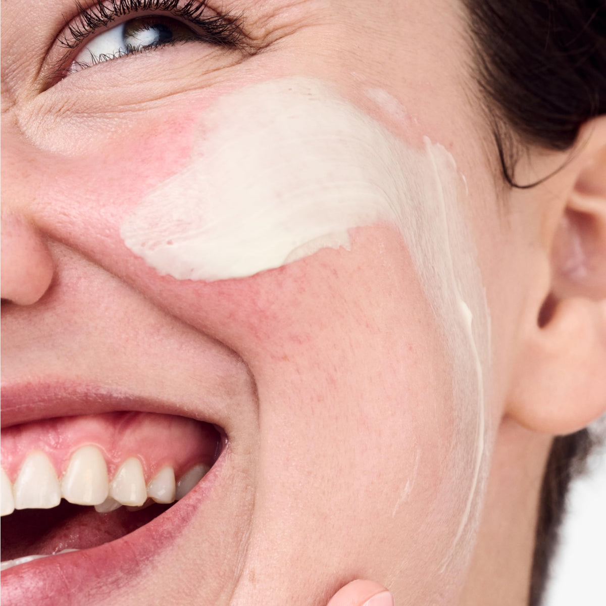 Clinique applying cream on hand to show easy absorption benefit