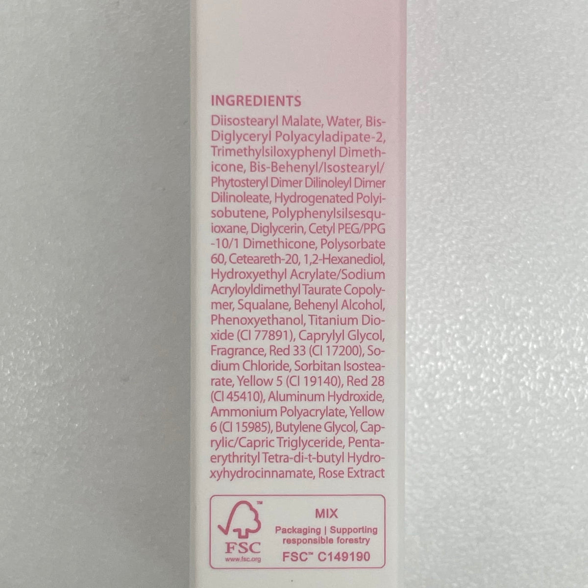 CLIO PROFESSIONAL size comparison next to coin illustrating compact travel-friendly tube