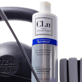 CLn SportWash 12 fl oz bottle next to hand for scale and portability