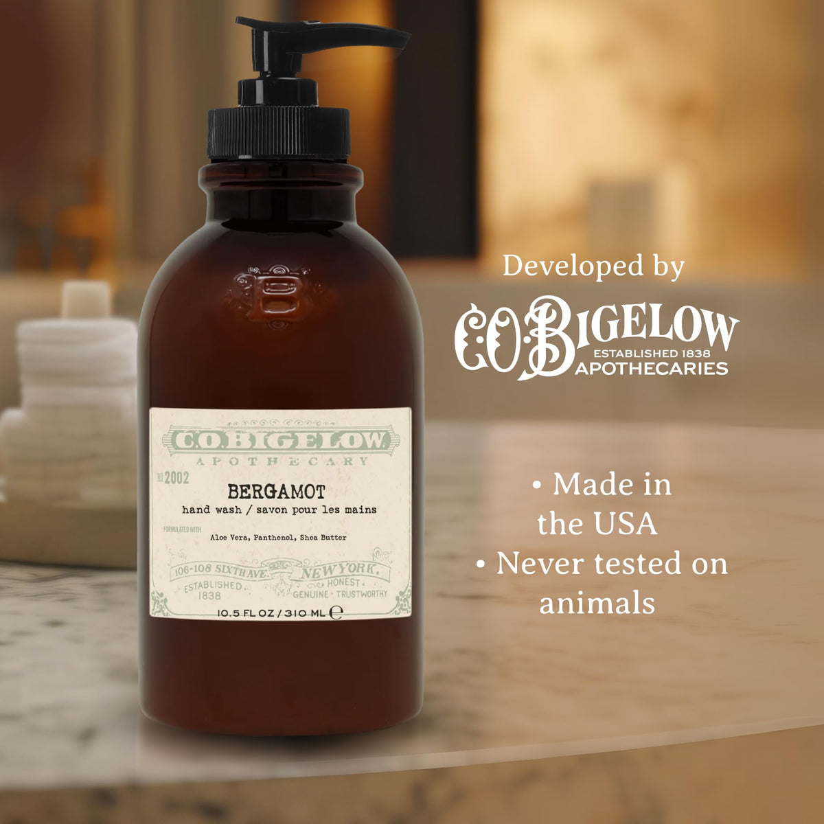 C.O. Bigelow bottle beside hands to show 10.5 fl oz size and real scale