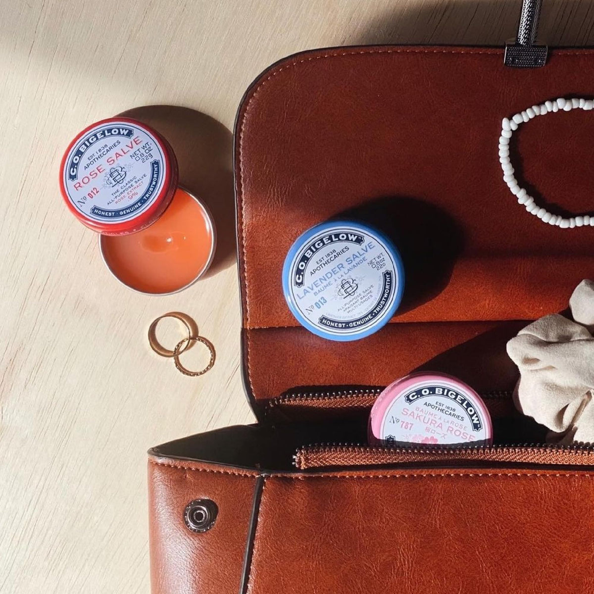 C. O. Bigelow applying salve to lips for instant moisture and subtle fragrance