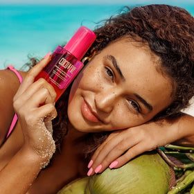 Coco & Eve applying oil after sun to legs showing hydrated glowing benefit