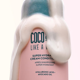 Coco & Eve conditioner being applied in shower to show quick, even conditioning benefit