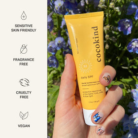 Applying Cocokind Daily SPF on face demonstrating lightweight blendability