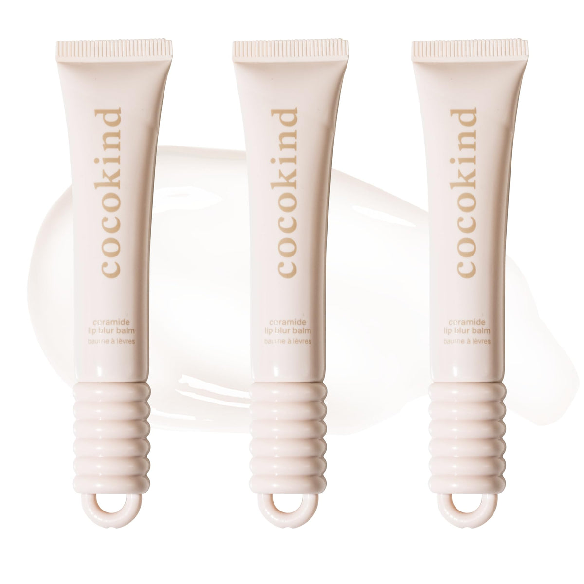 cocokind front view of three clear balm tubes, shows compact design and glossy finish