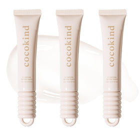 cocokind front view of three clear balm tubes, shows compact design and glossy finish