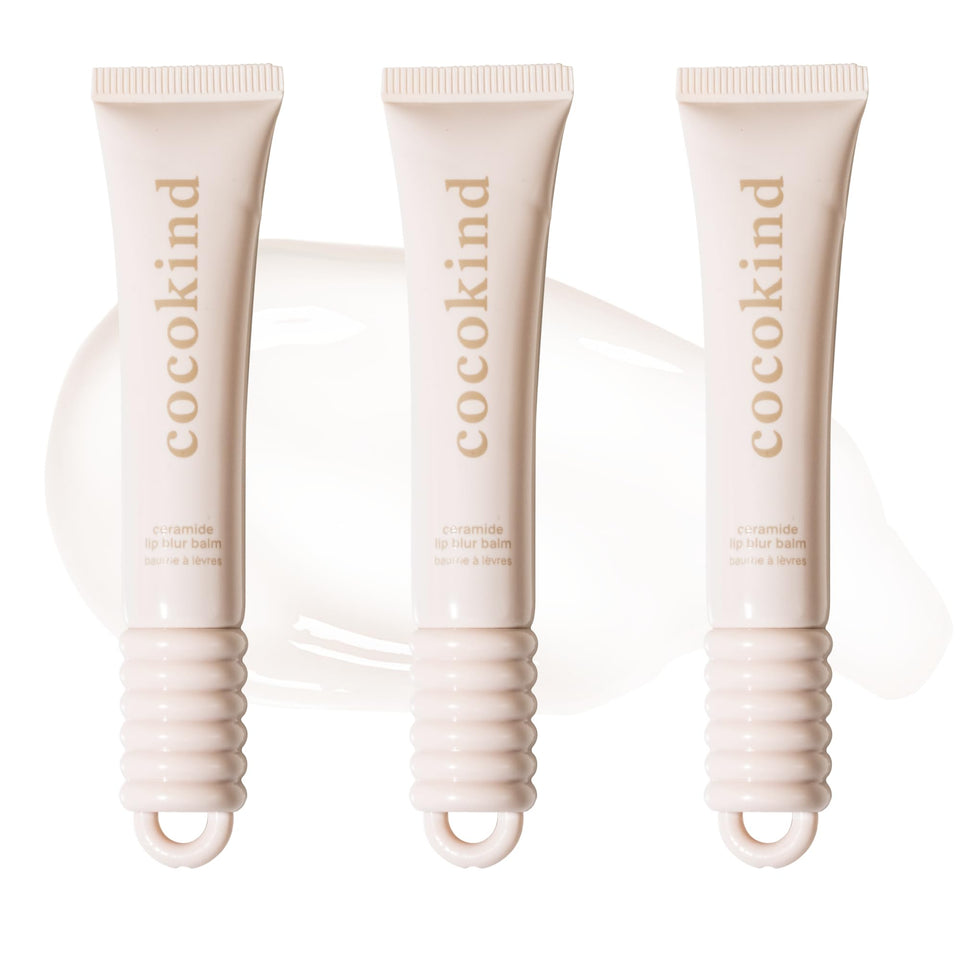 cocokind front view of three clear balm tubes, shows compact design and glossy finish