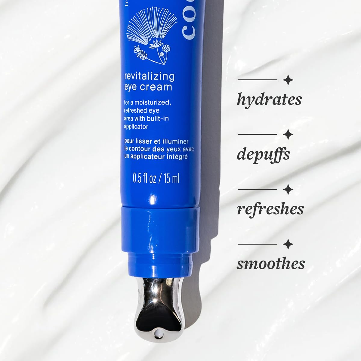 Cocokind tube beside coin to show compact travel-friendly size