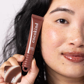 Cocokind balms inside a handbag showing portability and daily-ready protection benefit