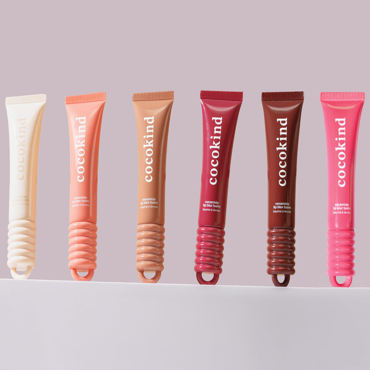 Cocokind open tube close-up showing balm bullet texture and smooth application benefit