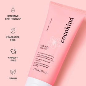 Cocokind tube next to common items for scale, shows travel-friendly size