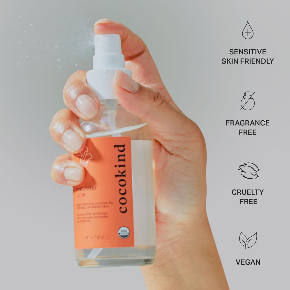 Cocokind toner misting on model's face to demonstrate instant refresh