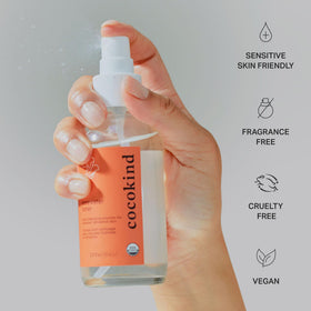 Cocokind toner misting on model's face to demonstrate instant refresh