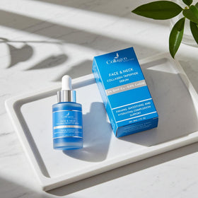 Collagen Tripeptides bottle in hand showing 1 fl oz scale for dosing and travel