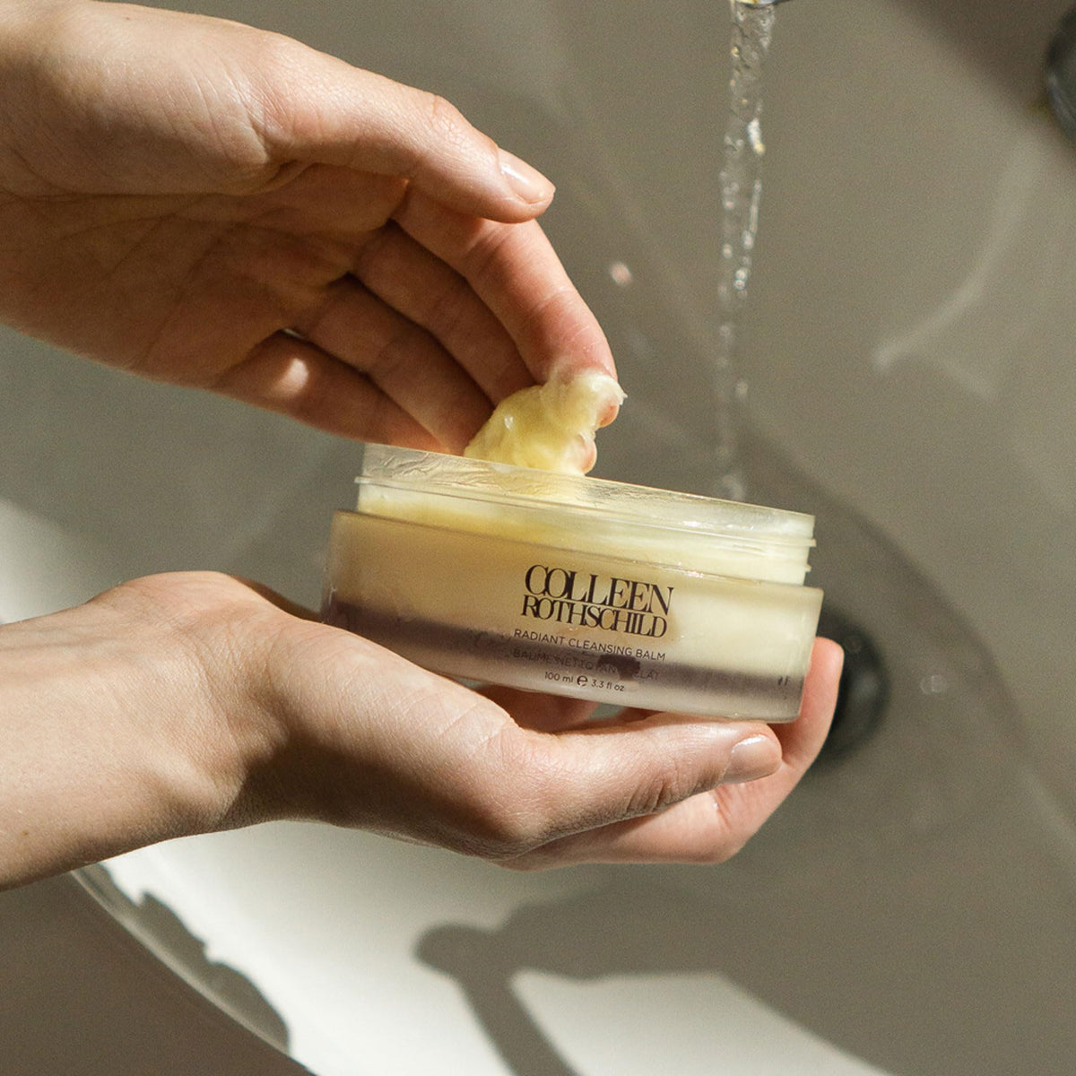 COLLEEN ROTHSCHILD balm being massaged in hand for effective makeup removal