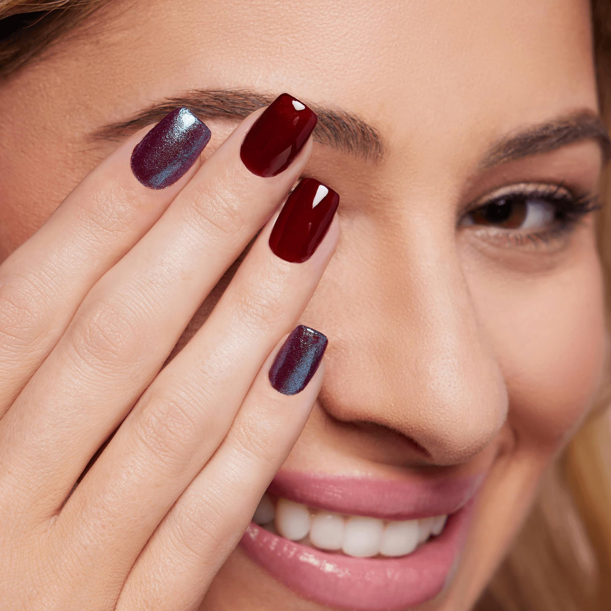 Color Street layered over dark polish showing intensified color shift benefit