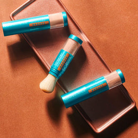 Colorescience brush-on shield bronze swatch on skin showing warm bronzed finish