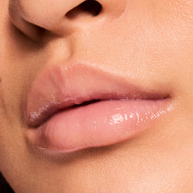 ColourPop application on lips showing sheer vanilla tint and luminous shine benefit