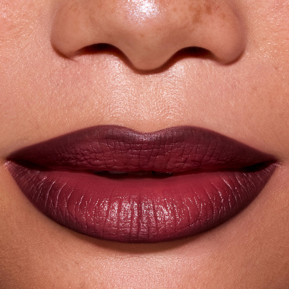 Colourpop New Love swatch on arm demonstrates warm burgundy-brown shade depth for shade selection