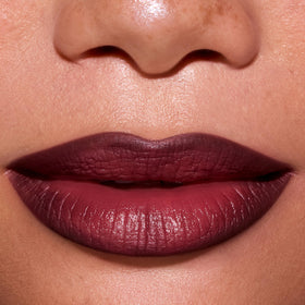 Colourpop New Love swatch on arm demonstrates warm burgundy-brown shade depth for shade selection
