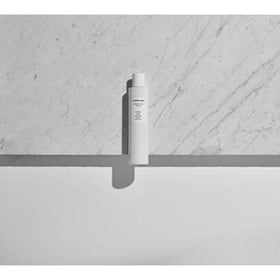 Comfort Zone bottle beside a coin for scale, conveys 200ml size clarity