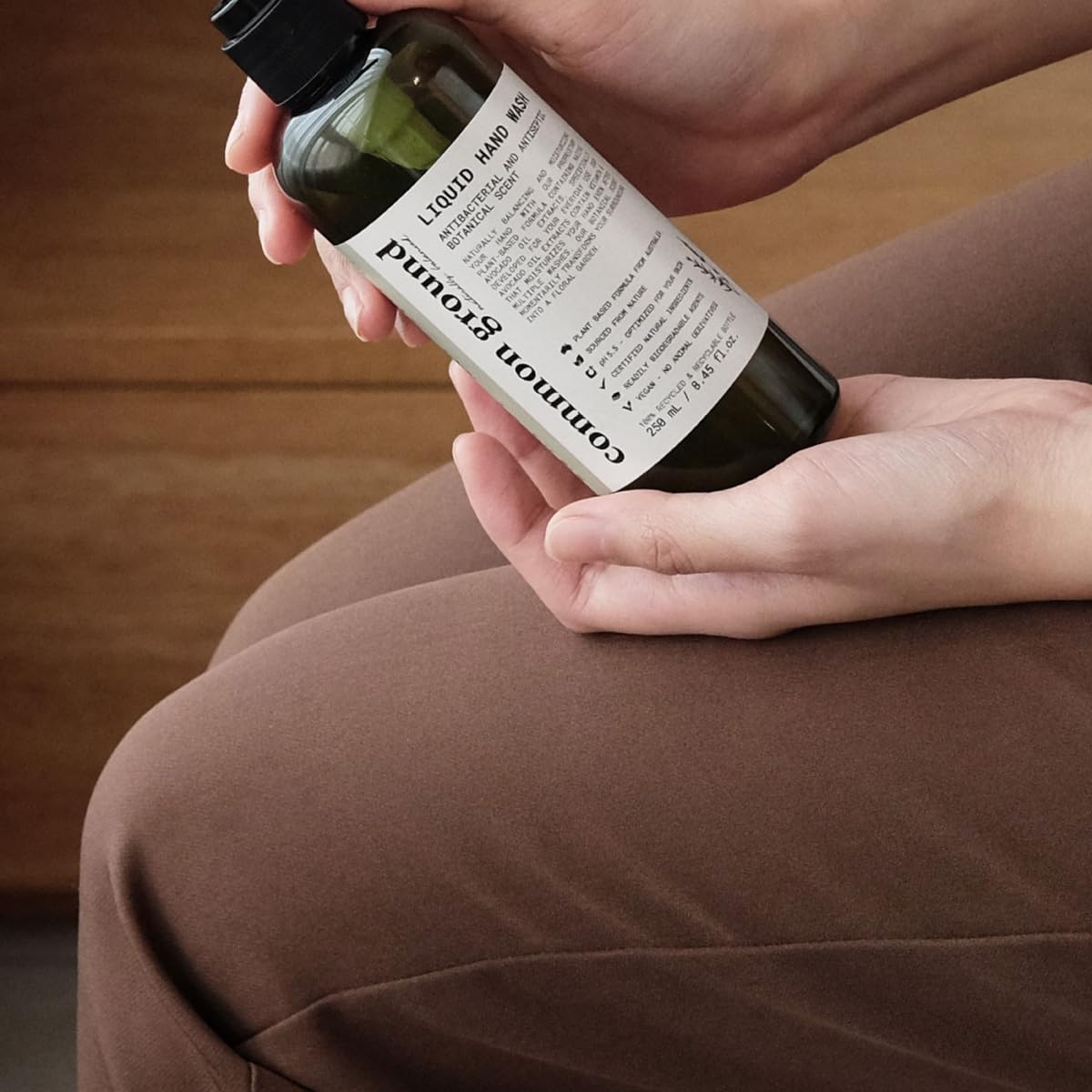 COMMON GROUND bottle staged in a bathroom to suggest everyday routine and aesthetic appeal