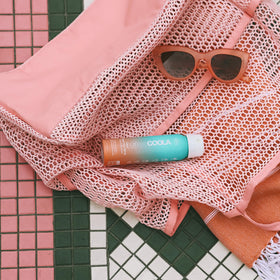 COOLA spray being applied from hand demonstrating quick, even coverage benefit
