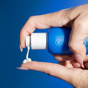 COOLA application on hand showing smooth, non-greasy finish benefit