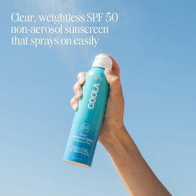 COOLA clear spray texture close-up showing quick absorption