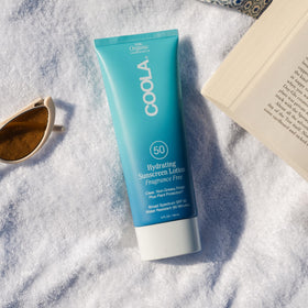 COOLA clear texture on hand demonstrating lightweight moisturizing feel