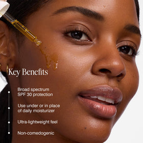 COOLA drop of firming face oil texture closeup showing lightweight absorption benefit