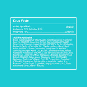 COOLA lip balm in hand showing travel size convenience and on-the-go protection