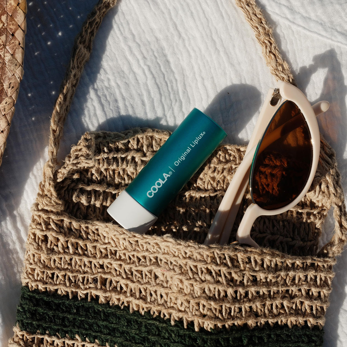 COOLA Liplux raspberry and avocado butter close-up highlighting hydration