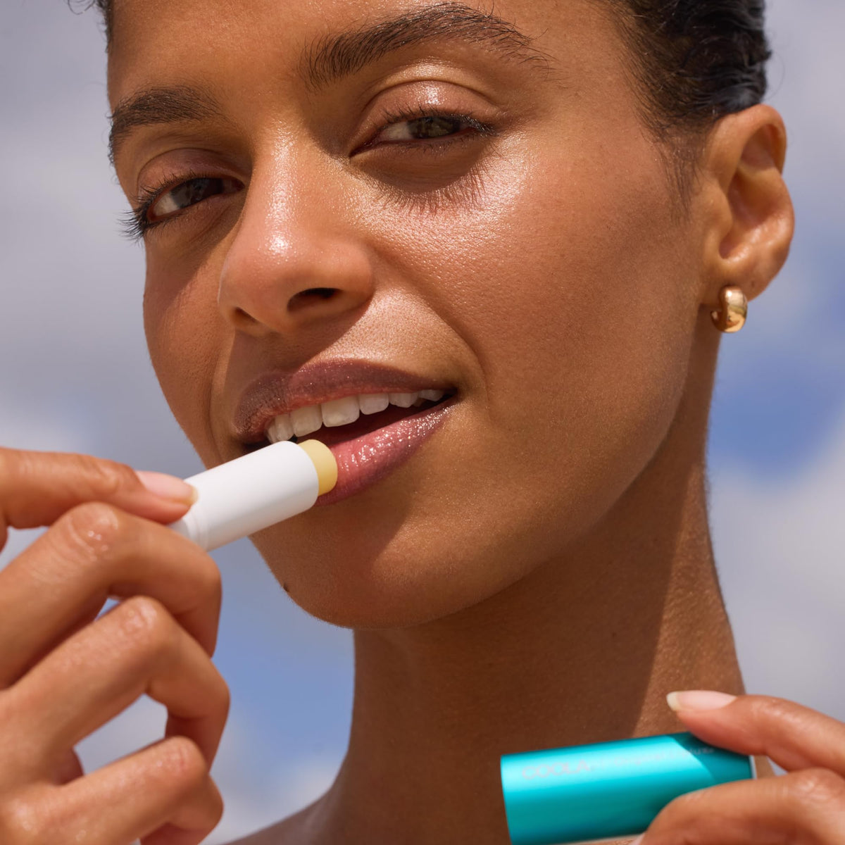 COOLA Original Liplux SPF 30 lip balm tube showing moisturized lips benefit
