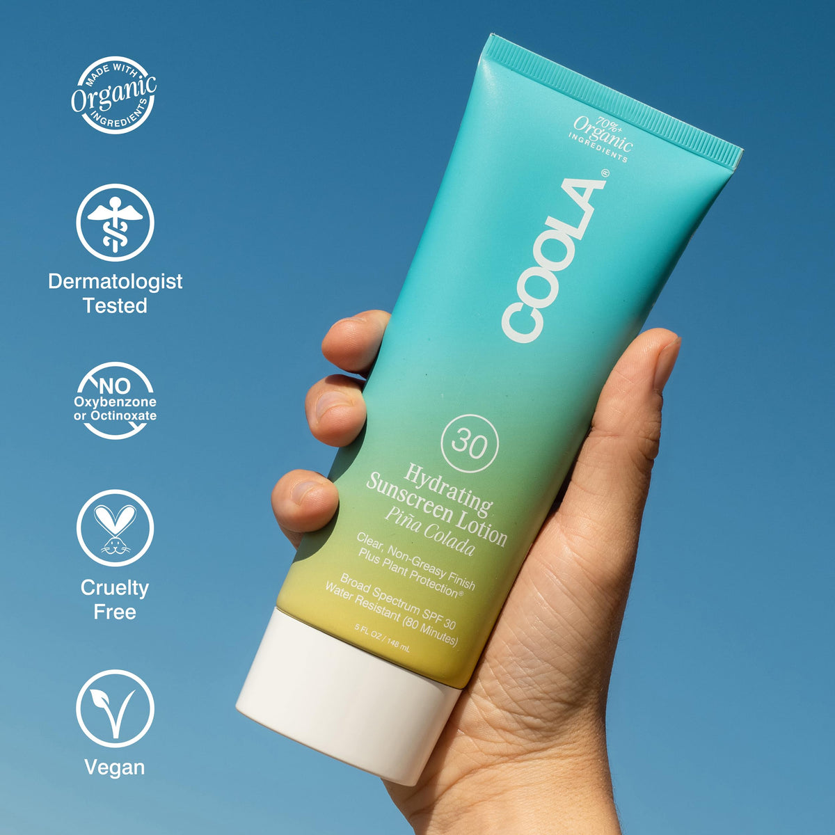 COOLA 5 fl oz bottle beside a smartphone illustrating travel-friendly compact size