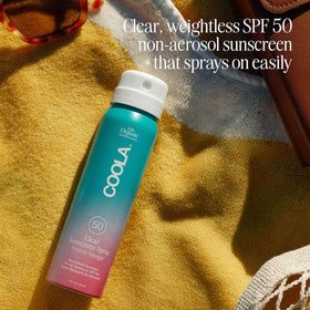 COOLA travel bottle in hand showing compact size and portability