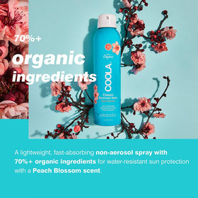 COOLA bottle held in hand showing size and portability for travel