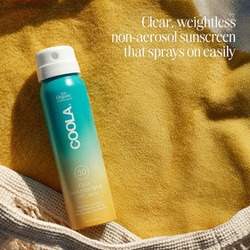 COOLA travel-size bottle in hand illustrating easy portability and TSA-friendliness