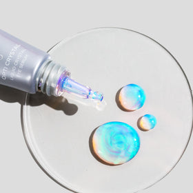 COSMEDIX applied under eye with fingertip showing targeted de-puffing action