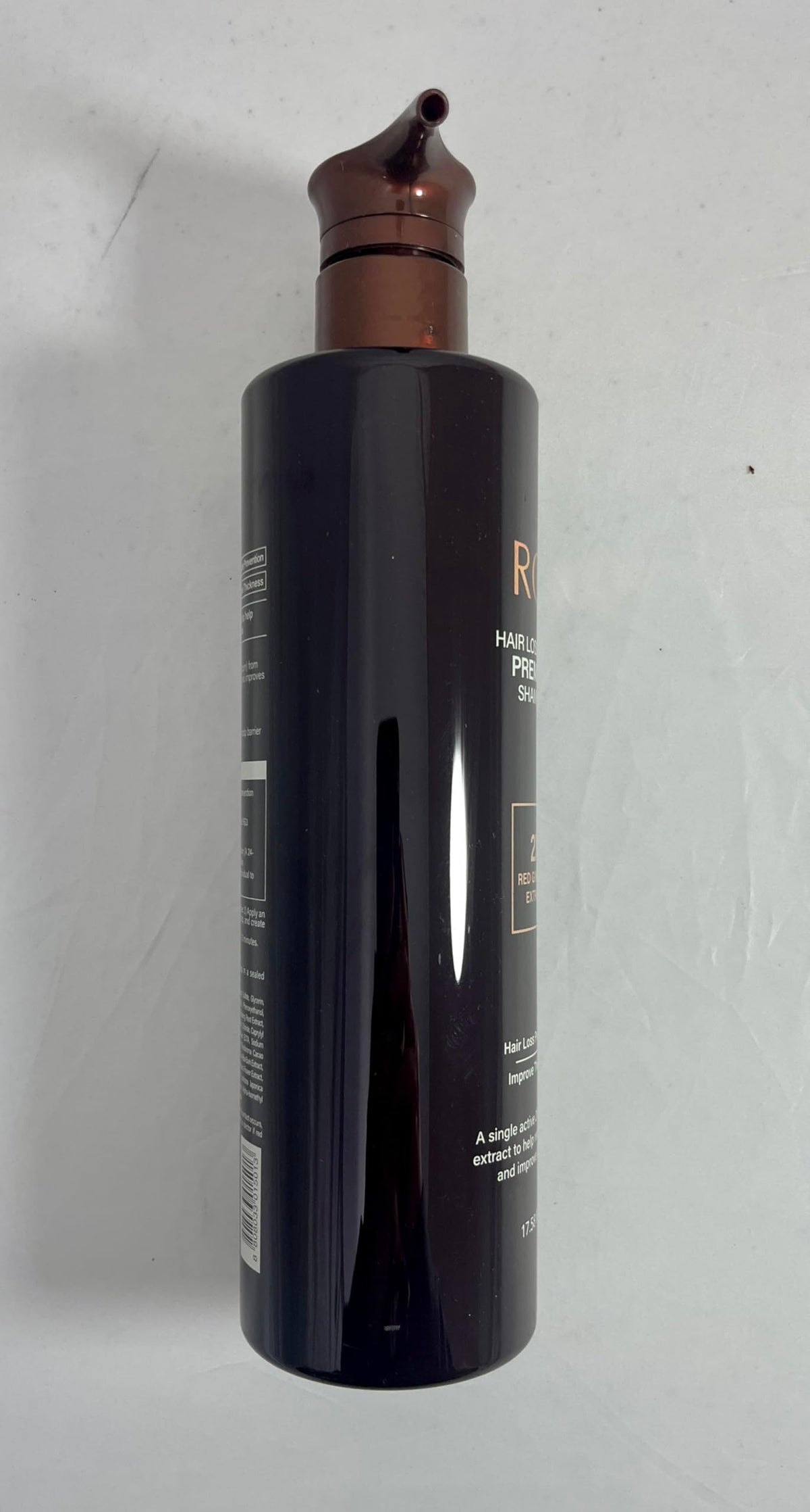 COSMOCOS RG3 shampoo in shower being massaged into scalp for strength
