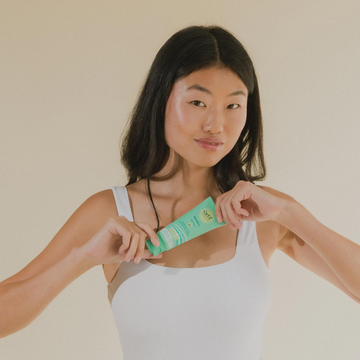 CoTZ being rubbed on forearm to show even body coverage and blendability