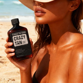Applying Crazytan oil to forearm to demonstrate smooth, non-greasy absorption