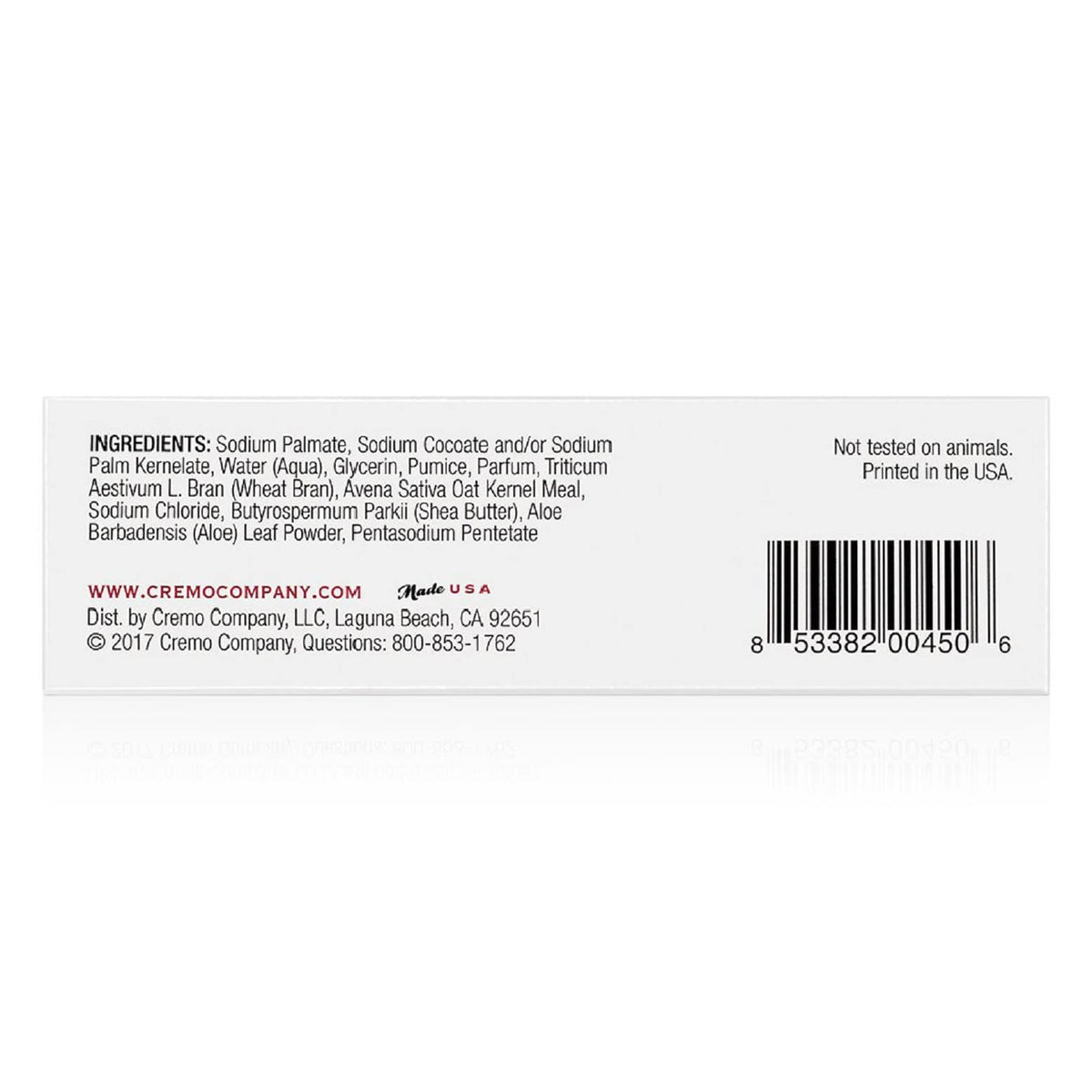 Cremo travel-size bar beside toiletries for convenient portability benefit