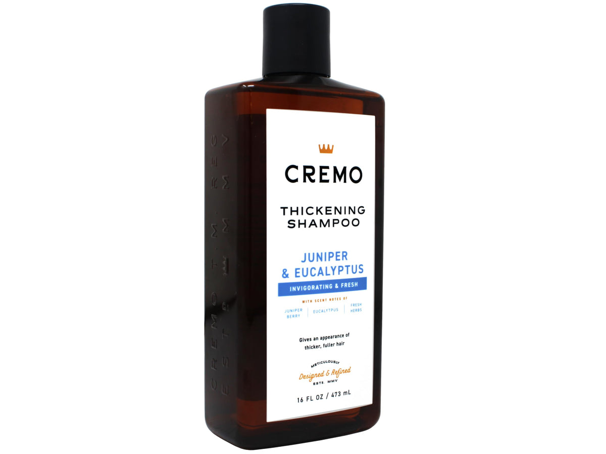 Cremo bottle next to hand showing 16 fl oz scale and travel-friendly benefit