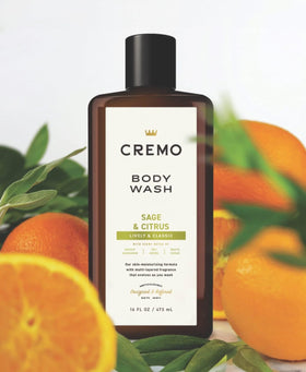 Cremo bottle held in hand for scale, illustrates 16 fl oz size and portability