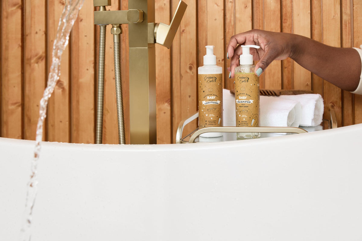 Baby in bathtub using Cristina's Curls set showing calmer, quicker bath time
