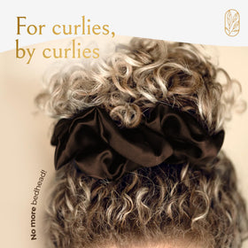 Curlfriend Collective scrunchie on pillow for nighttime use showing gentle sleep protection
