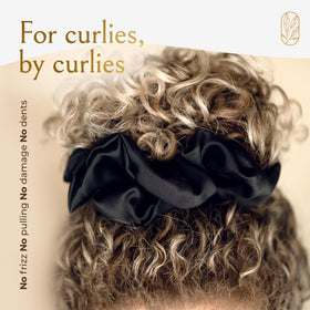 Curlfriend Collective scrunchie in hand for size comparison, fits thick hair