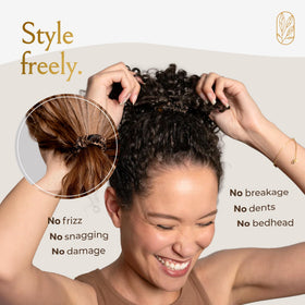 Curlfriend Collective scrunchies on nightstand illustrating sleep-friendly, protective use