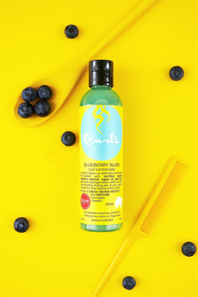 Curls Blueberry Bliss applied to wet curls demonstrating defined, frizz-free results
